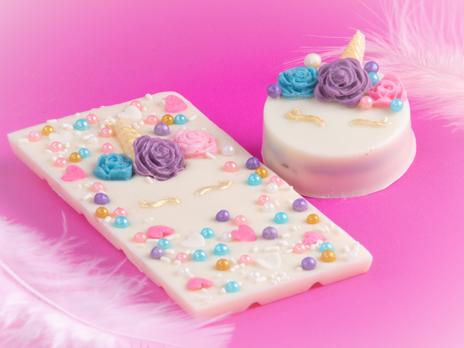 Closeup macro shot of fairytale-themed candies on a pink surface
